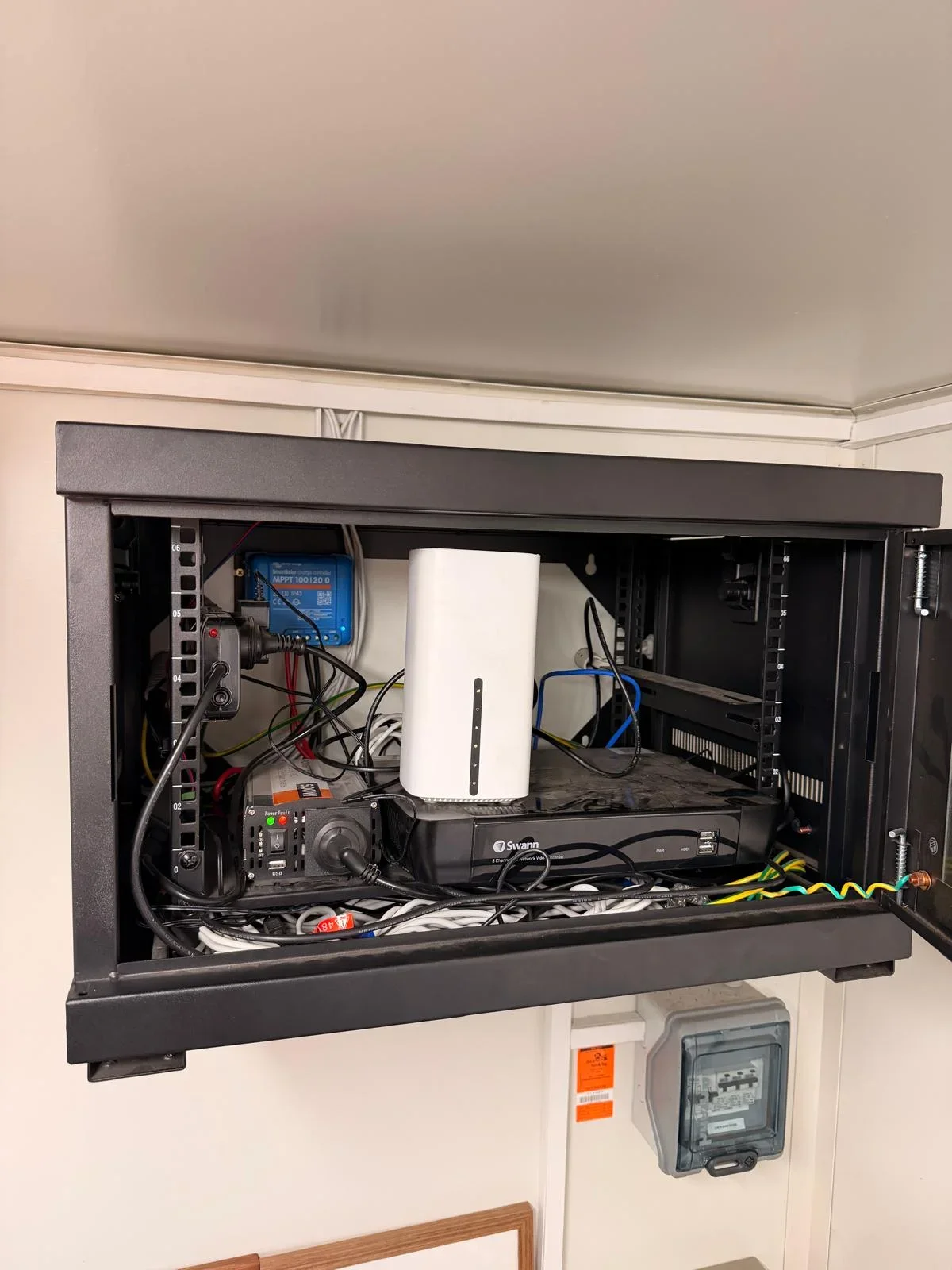 Rockingham mobile office before the upgrade, with the original 5G modem, Swann recorder and crowded cabinet cabling